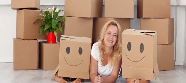 Happy people having fun in a new home with cardboard boxes and a plant; Shutterstock ID 84129238; PO: 1