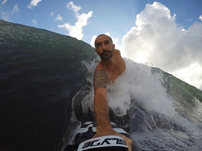 guy surfing with handboard