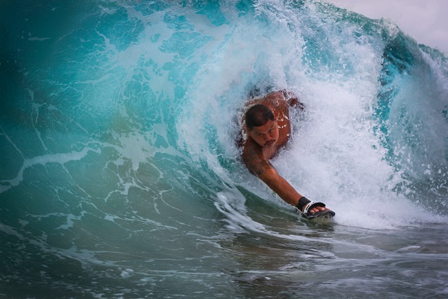 guy surfing with handboard