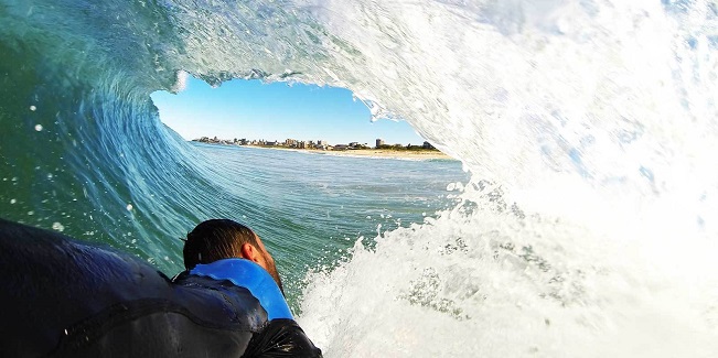 guy surfing with handboard