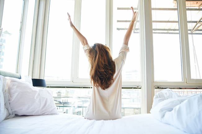 happy girl waking up in the morning