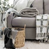 grey sofa bed with different types of throw blankets