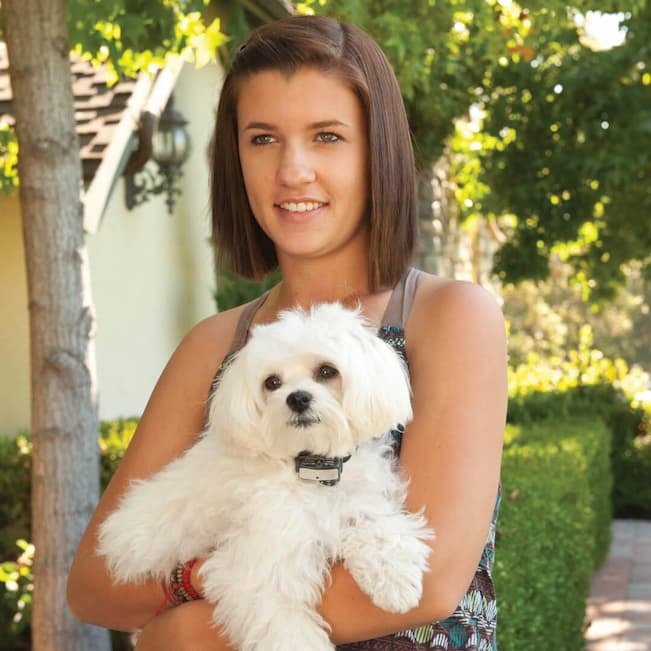 girl holding her dog in her hands