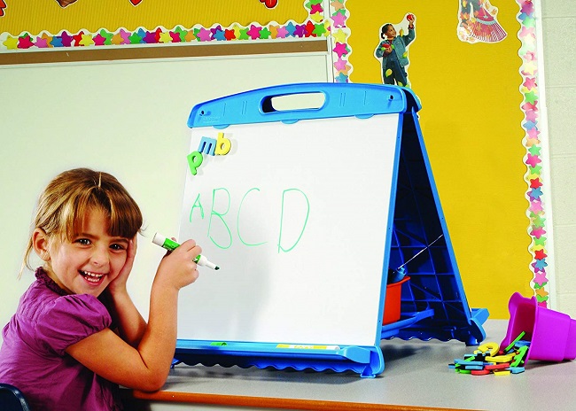 Kid drawing on magnetic board