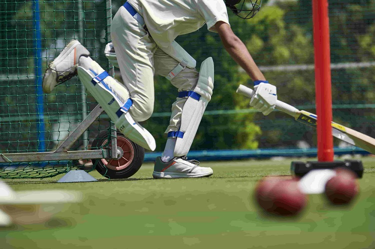 man wearing cricket pads