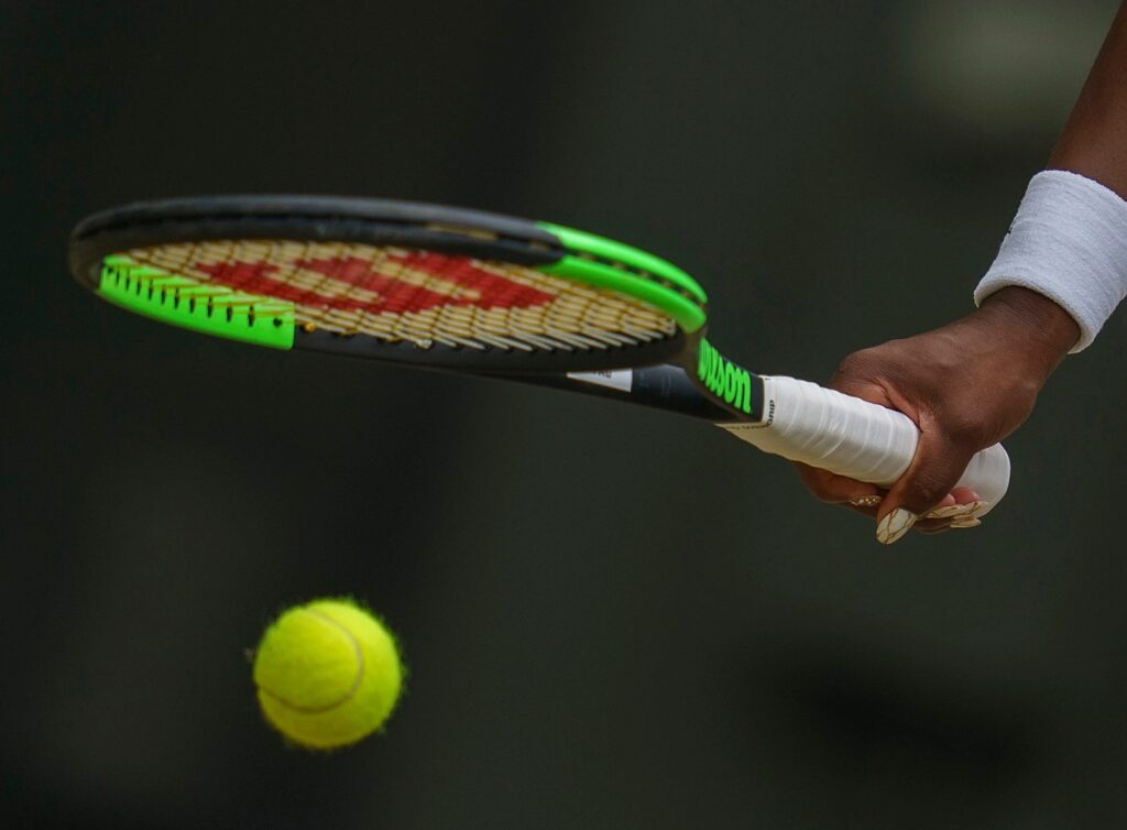 Holding a tennis raquet