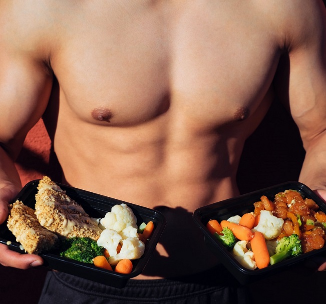 picture of a man holding two portions of healthy food 