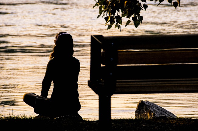 picture of a person relaxing by water