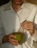 picture of a person holding a green beverage