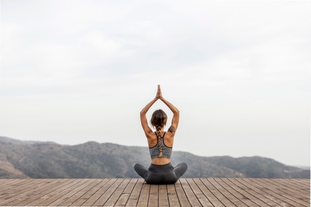 back-view-woman-doing-yoga-outdoors