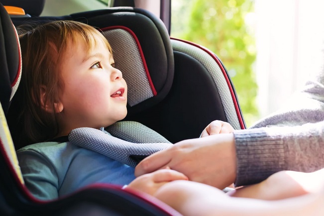 strapping out and about baby in car seat 