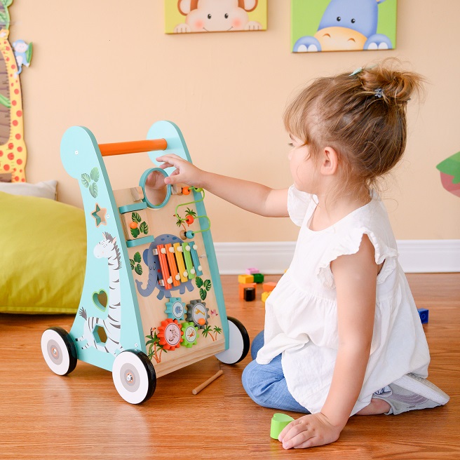 picture of a baby playing with activity walker sitting on the ground