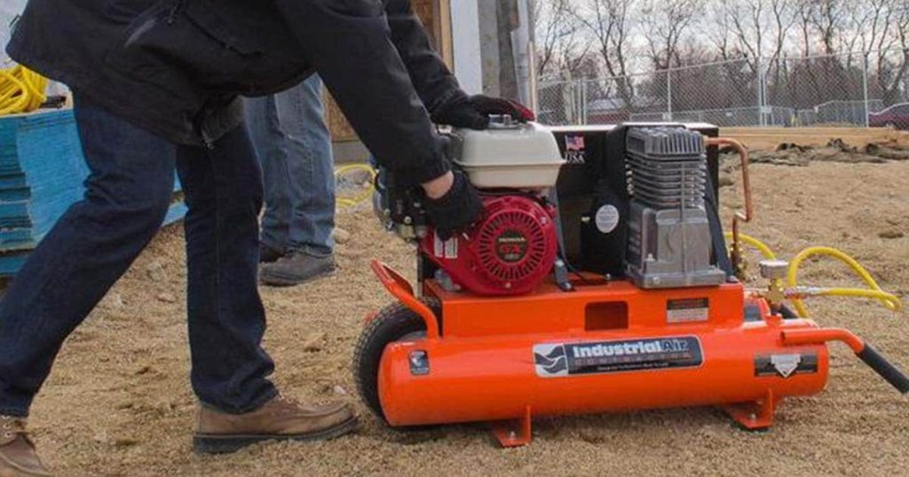 Man starting a petrol compressor