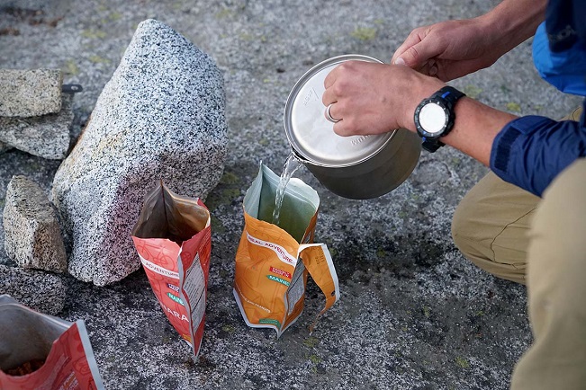 Close-up of pouring hot water in freeze dried meal