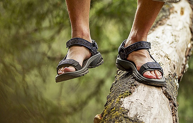 picture of a men in a sandals walking on a wood 