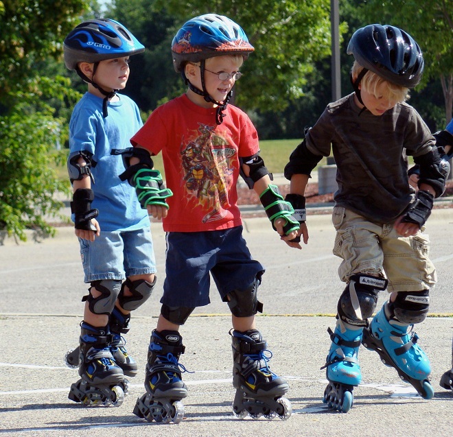 picture of three little boys driving adjustable boys inline roller skates in the neighbourhood 