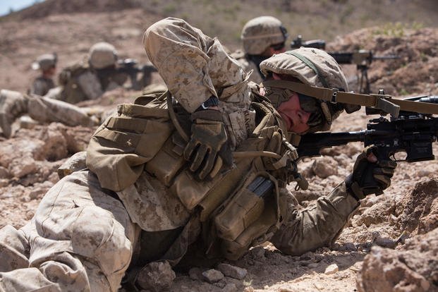 Soldier reaching to his ammo pouch to get ammo