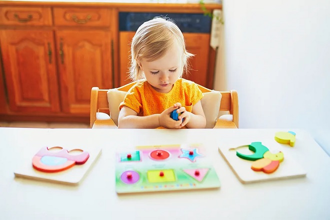picture of toddler playing with puzzle