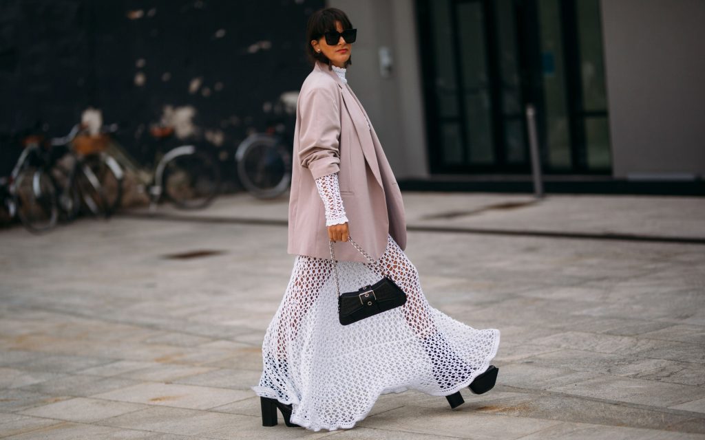 a woman wearing a white maxi dress
