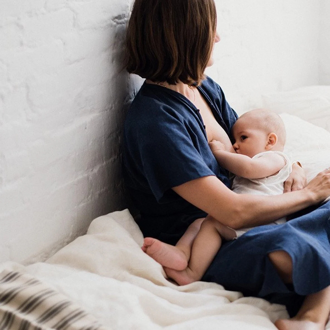 mum in button-down shirt breastfeeding