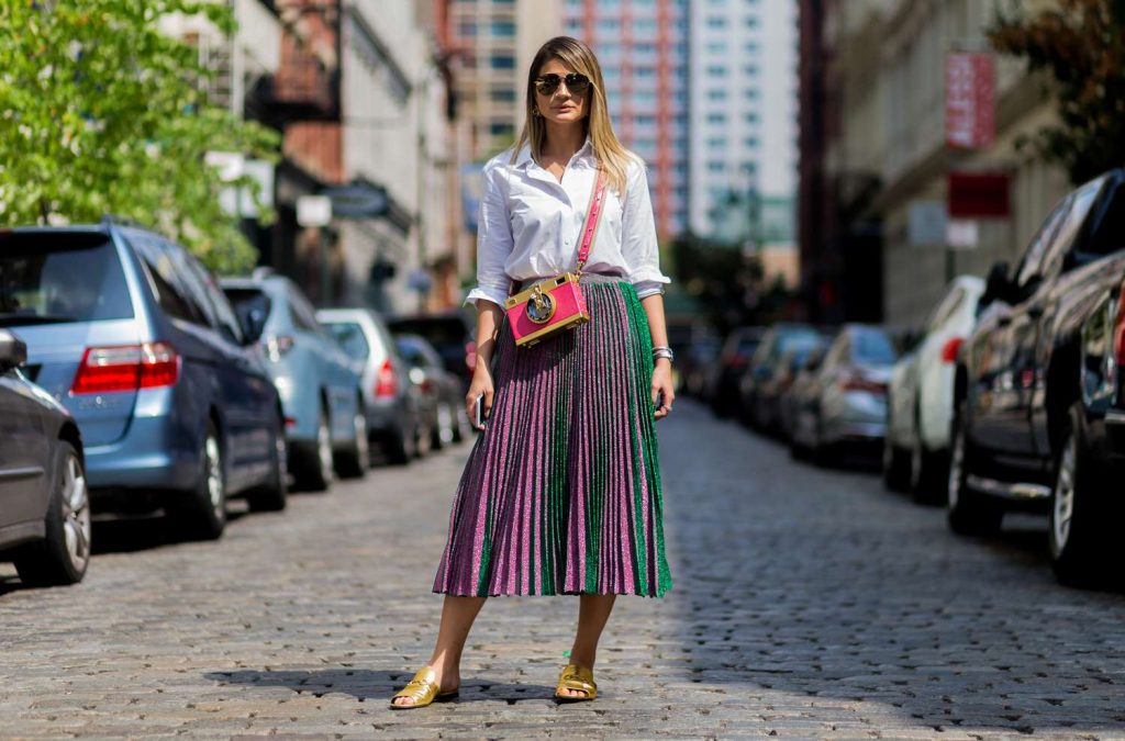 a woman wearing pleated skirt