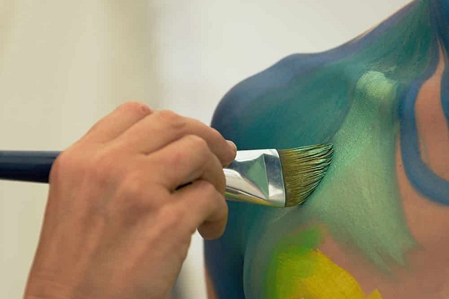 painting on a body with a brush