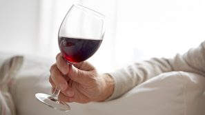 man holding a glass of red wine