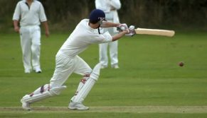 cricket player hitting a ball