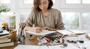 woman drawing with a pen